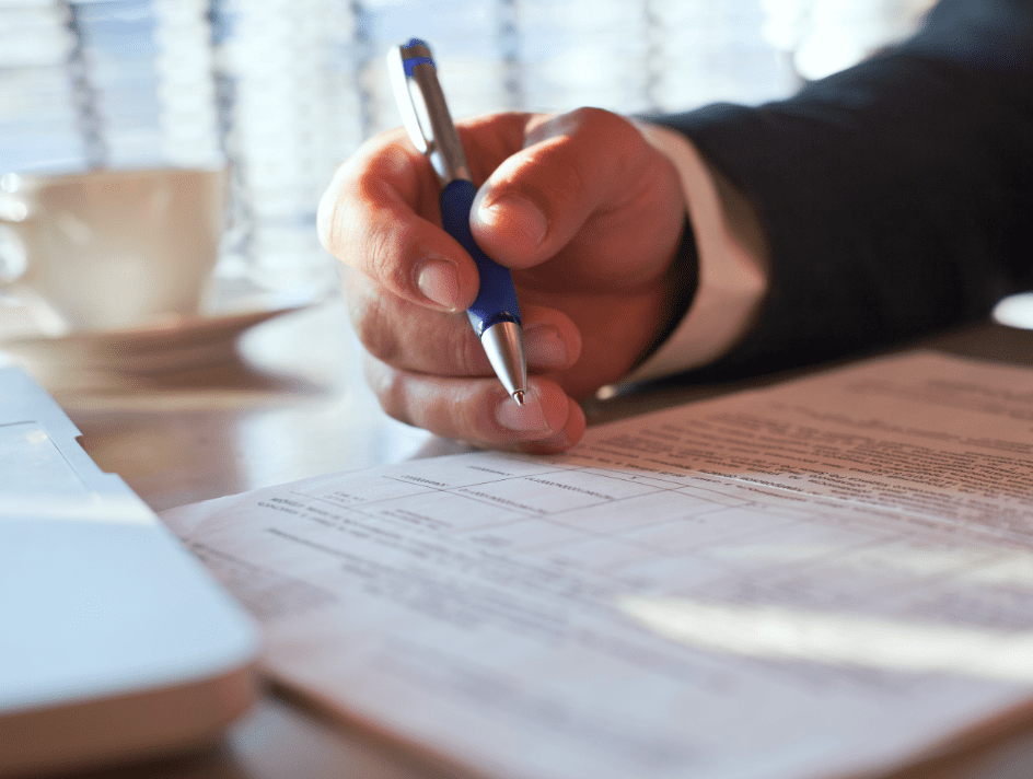 Person writing with Pen on Form