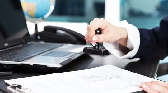 Person stamping a document