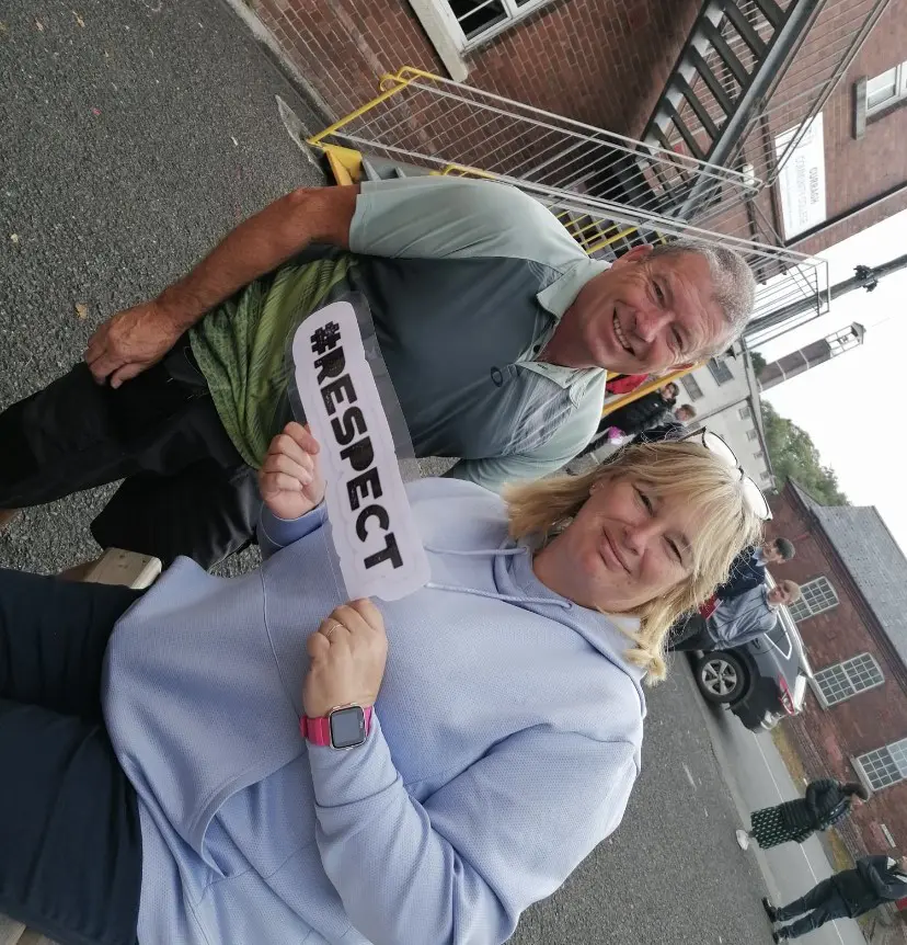 parents holding a #respect sign representing the Curragh Community College core ethos values 