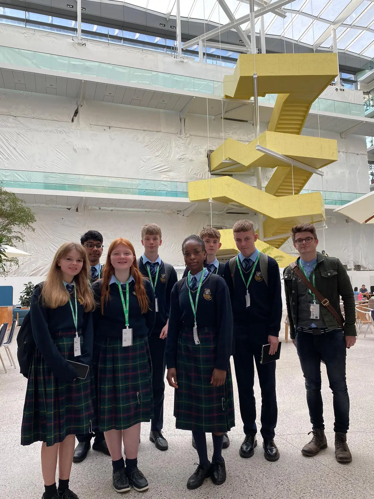 Group of Maynooth Community College students standing infront of yellow stairs at Meta Headquarters at Grand Canal dock