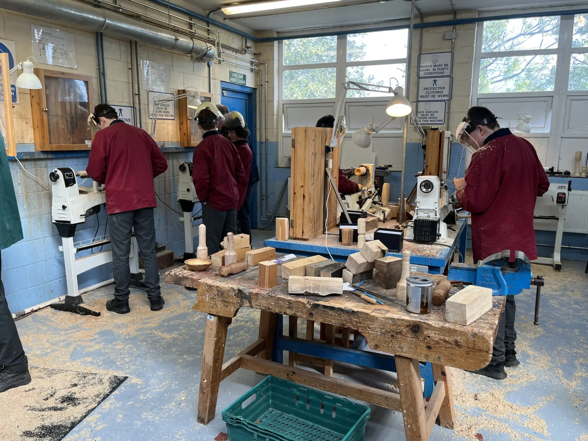 sixth class students at St. Conleths Community College in the woodwork room watching students use the machines 
