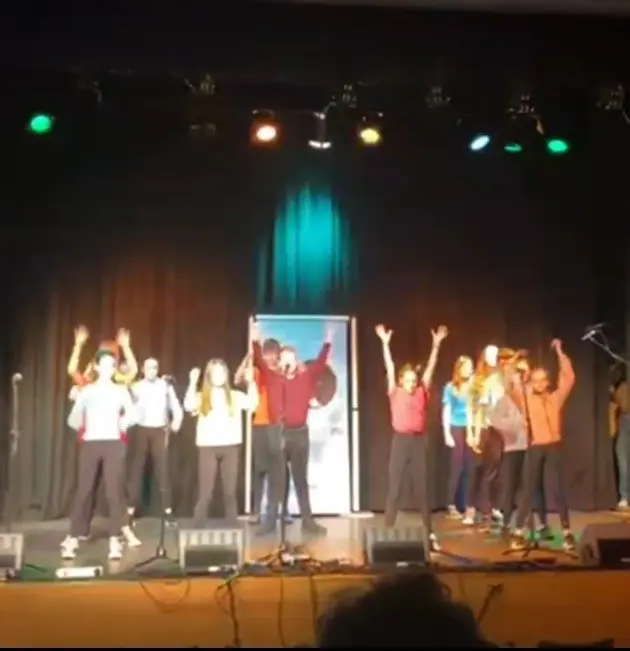 Gaelcholáiste Mhaigh Nuad students performing on stage in front of the crowd 