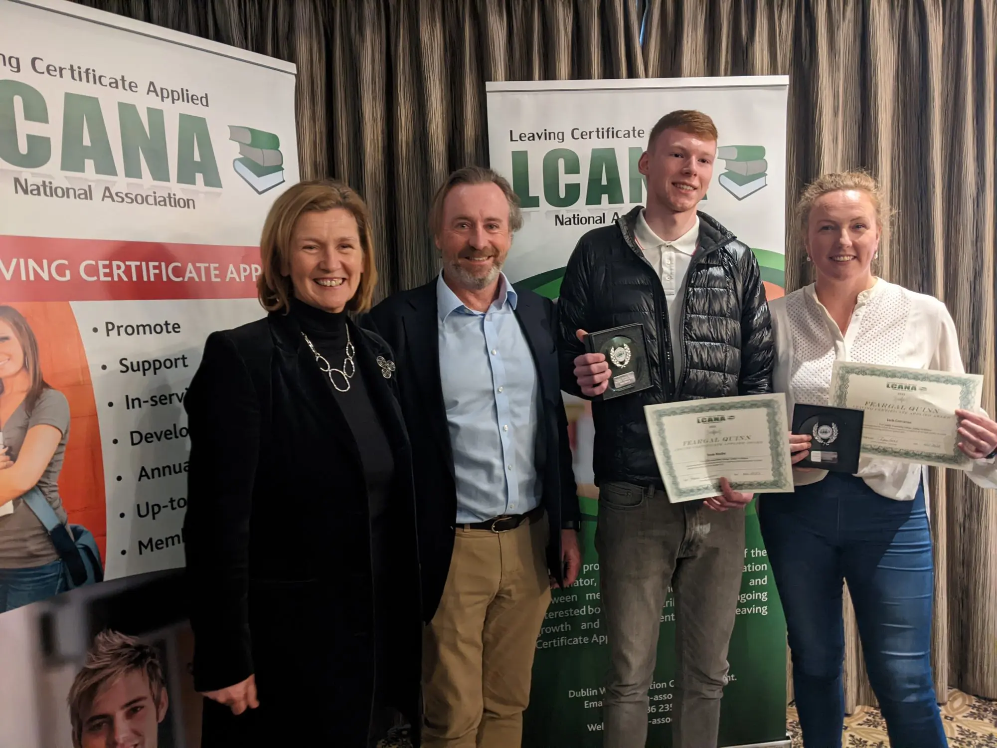Confey College student standing with the Coordinator of the LCA Programme from Confey College and presenter holding his award and certificate 