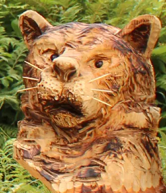 Wooden badger carving with a raised paw
