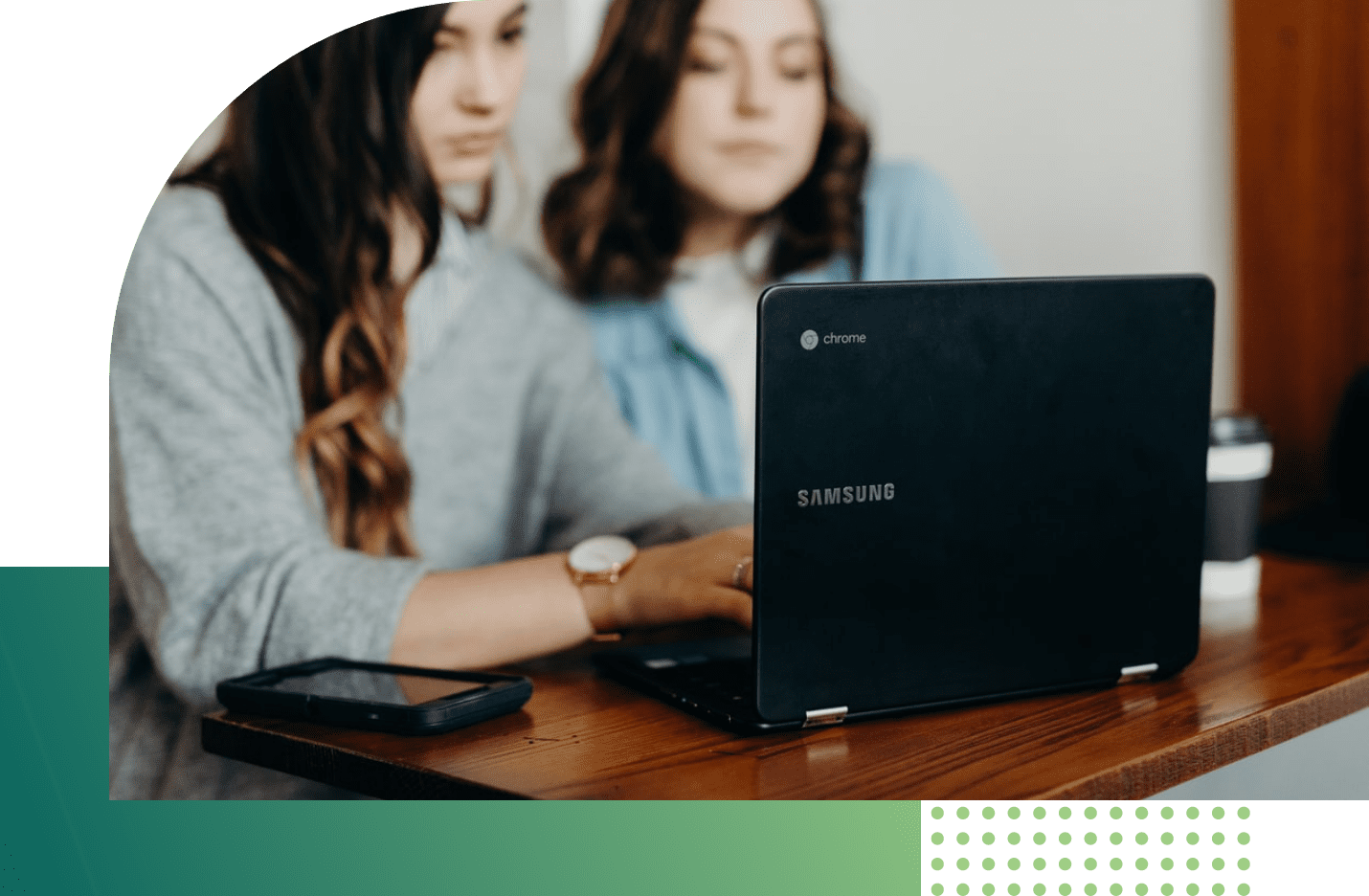 two girls looking at laptop screen