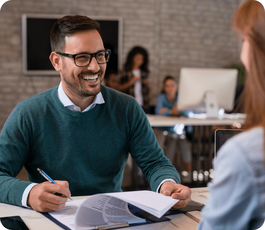 man smiling filling out a form
