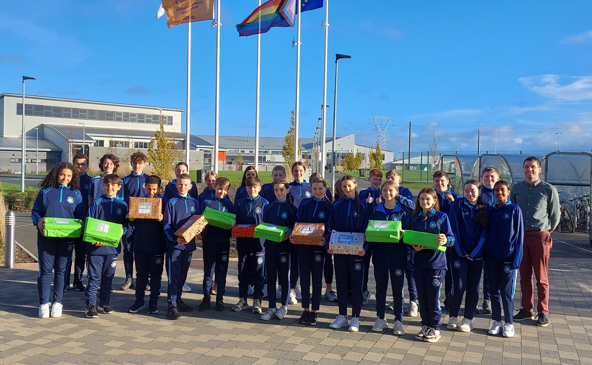 Student class holding their wrapped shoeboxes for the Team Hope Christmas shoebox appeal